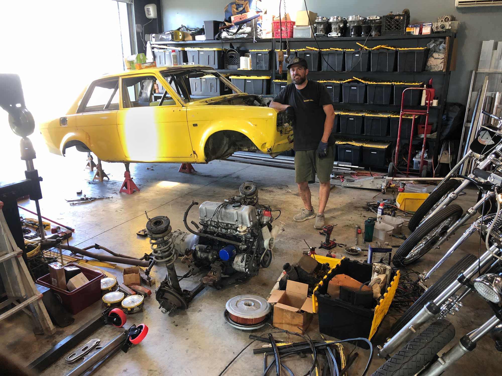Yellow Brock Buster Datsun on jack stands