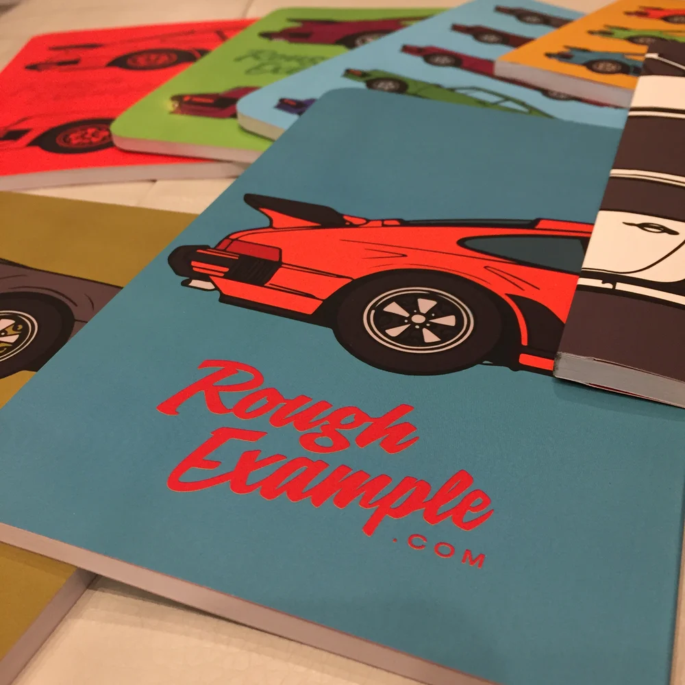 Notebook with photo of porsche on it