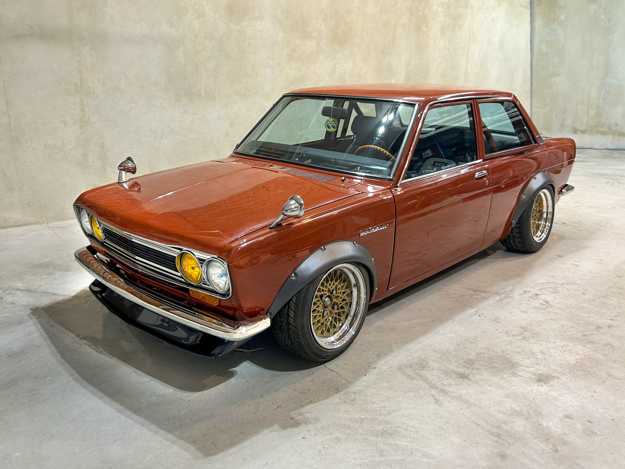 Brown 1971 Datsun 510 2-door parked in a garage